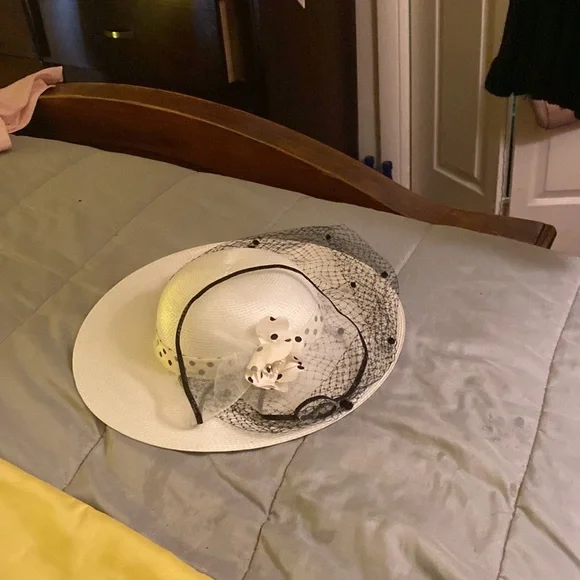 White hat polka dot netting over face net flower on side